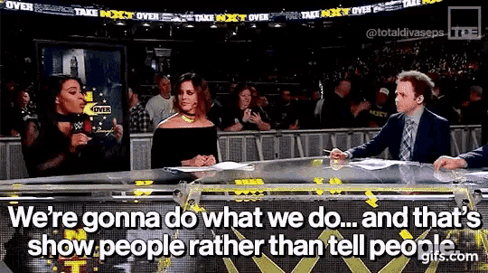 a man and two women are sitting at a table with the words we 're gonna do what we do ... and that 's show people