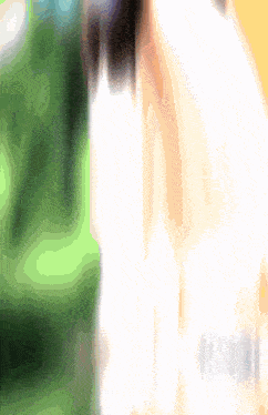 a blurred image of a person 's face with a green background