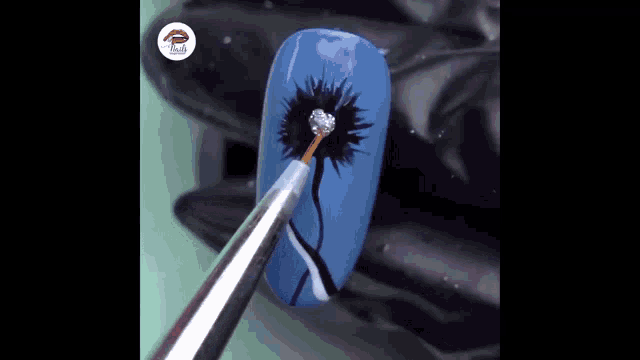a close up of a nail with a flower design