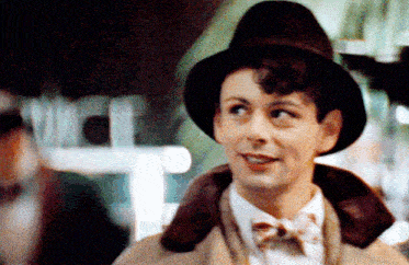 a man wearing a hat and a bow tie