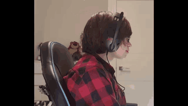 a person wearing headphones and a red plaid shirt