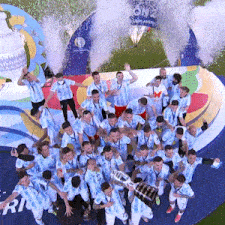 a group of soccer players are posing for a picture with a trophy in their hands