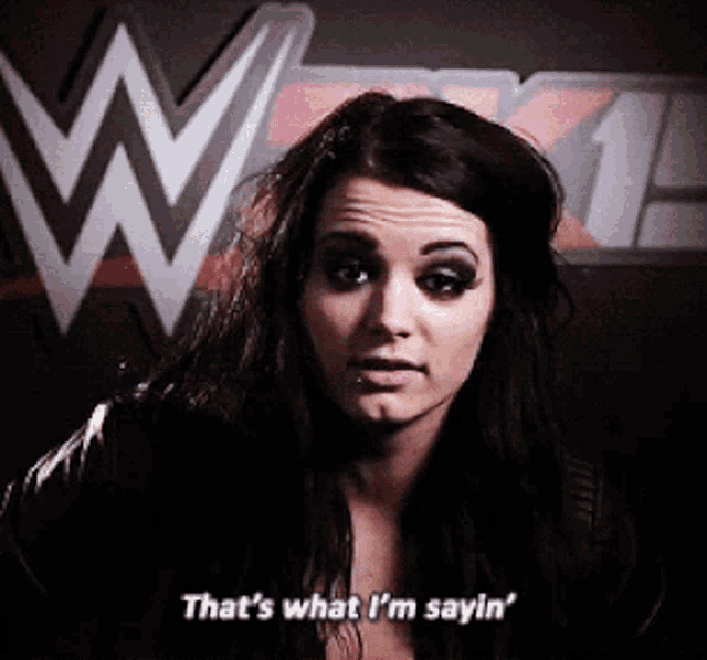 a woman says " that 's what i 'm sayin " in front of a wrestling logo