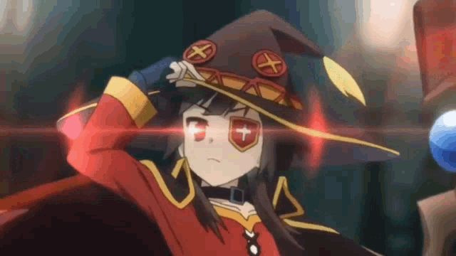 a girl wearing a witch hat and glasses is standing in front of a blue ball .