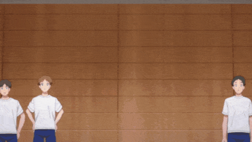 a group of people are standing in front of a wooden wall