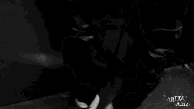 a black and white photo of a person 's hands with the words ' kritikal media ' on the bottom