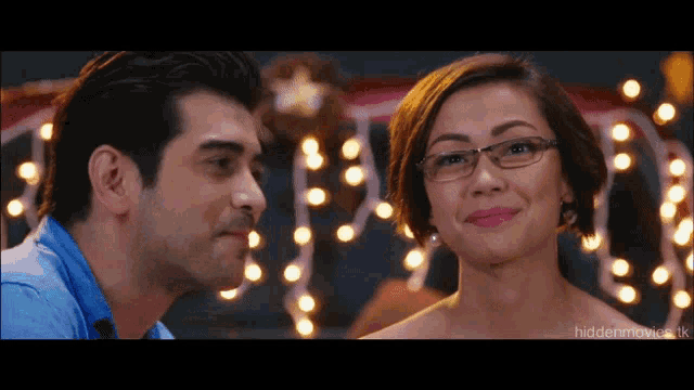 a man and a woman are looking at each other with the words hiddenmovie.uk at the bottom