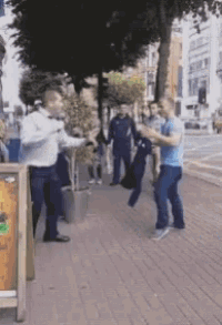 a group of men are standing on a sidewalk in front of a sign that says beer