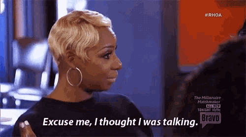 a woman with short blonde hair is talking to another woman .