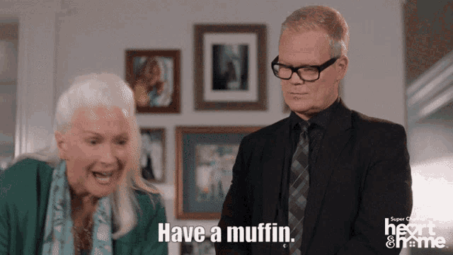 a man and a woman are standing next to each other and the man is saying have a muffin