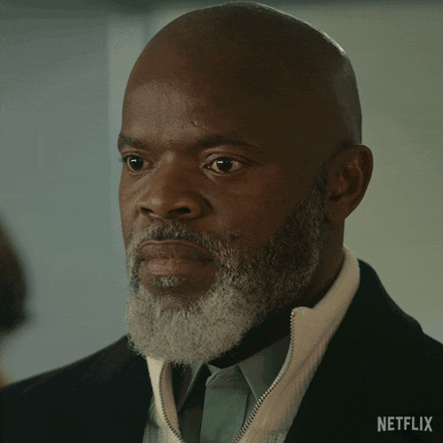 a bald man with a beard says " alright " in a netflix ad