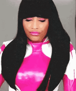 a woman with long black hair is wearing a pink and white costume with her eyes closed .
