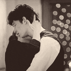 a black and white photo of a man and a woman hugging each other