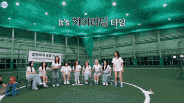 a group of women sitting on chairs in front of a sign that says it 's in korean