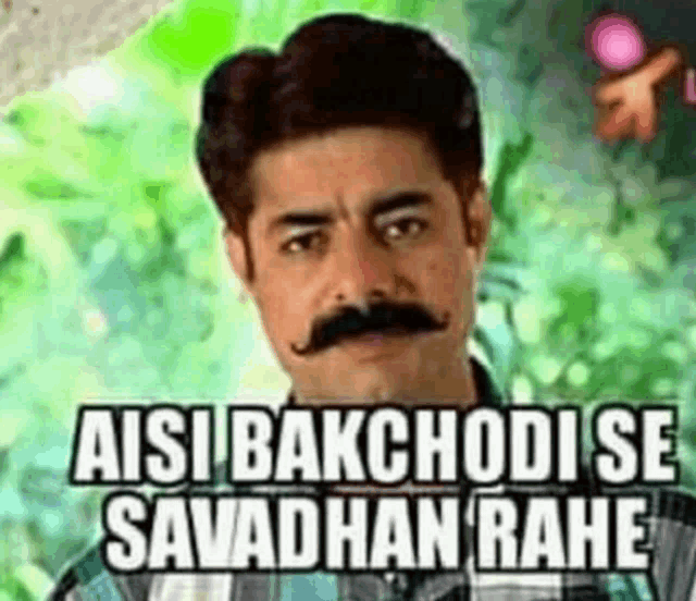 a man with a mustache is wearing a plaid shirt and says aisi bakchodi se savadhan rahe