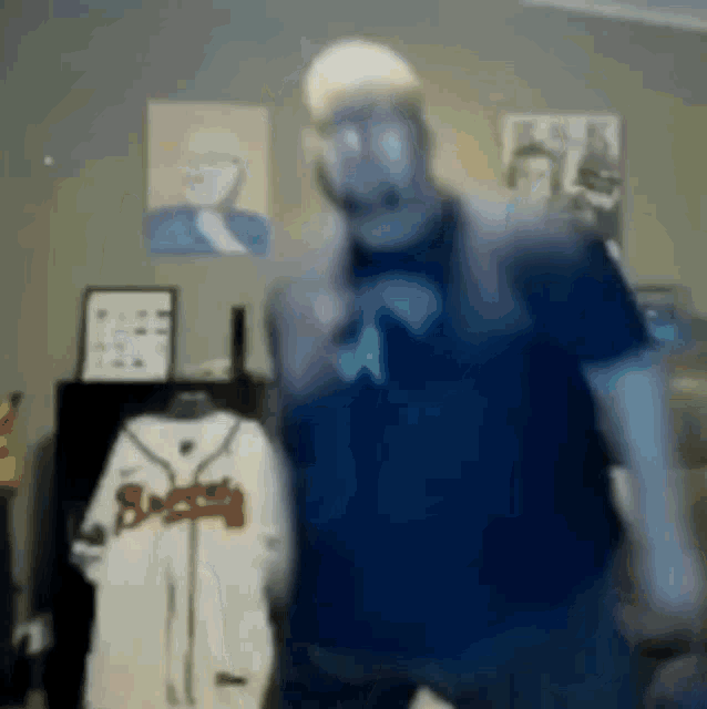 a blurry photo of a man in a braves shirt