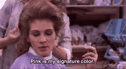 a woman is getting her hair dyed in a salon and says `` pink is my signature color . ''