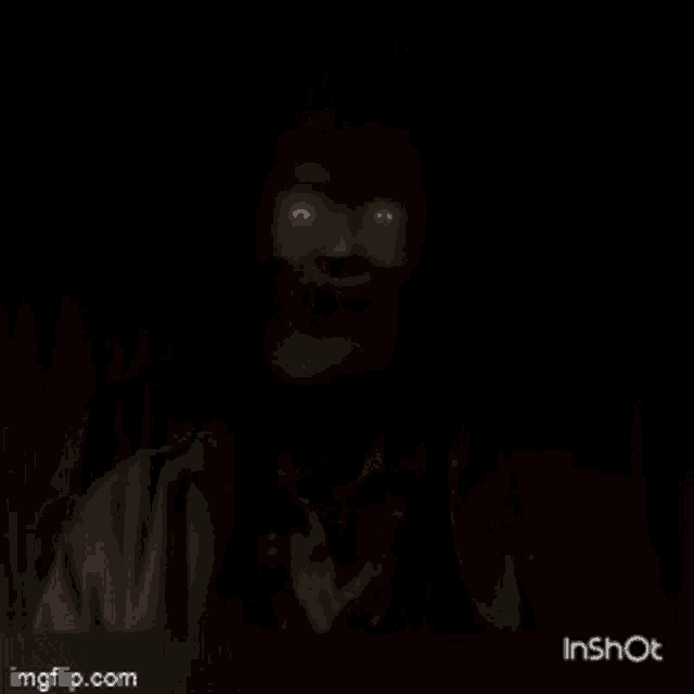 a video of a person holding a remote control with a red button