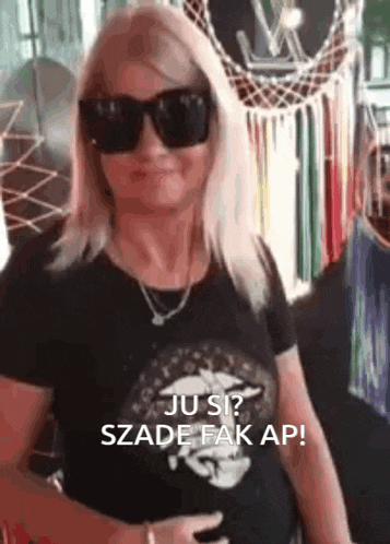 a woman wearing sunglasses and a black shirt says ju si ?