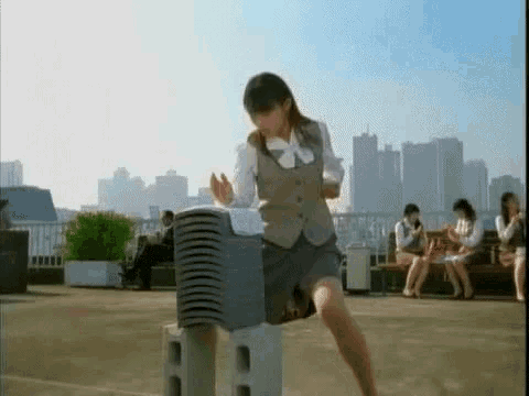 a woman is standing on a stack of concrete blocks .