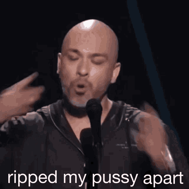 a bald man singing into a microphone with the words ripped my pussy apart written below him