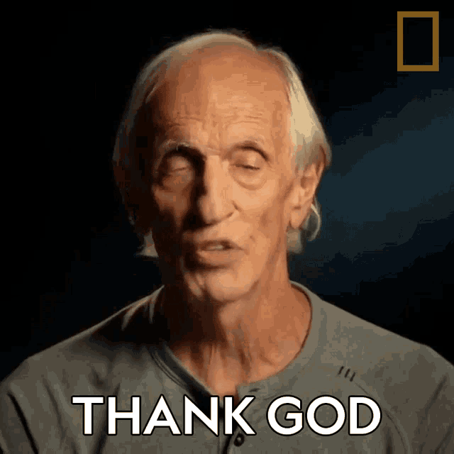 an elderly man says thank god in a dark room