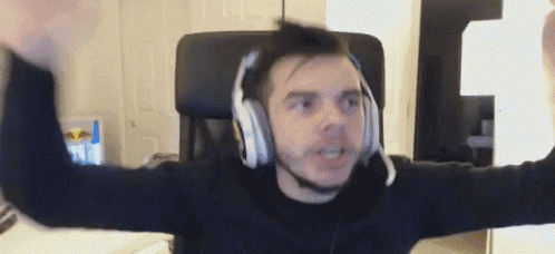 a man wearing headphones and a microphone is sitting in a chair