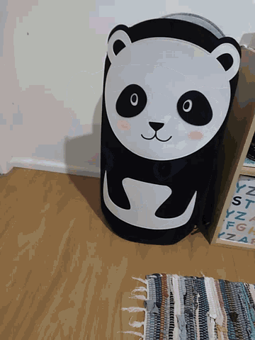 a black and white bag with a panda bear face on it