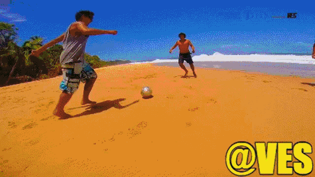 a man kicking a soccer ball on a beach with the words @ves written below him