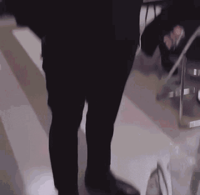 a man in a suit and tie is smiling and taking a picture of himself .