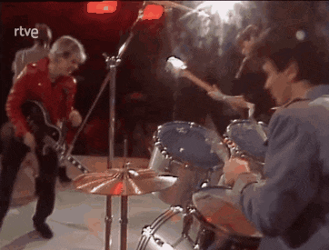 a group of men are playing instruments on a stage with the letters rtve above them