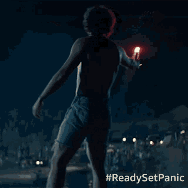 a man without a shirt is holding a red torch with the hashtag #readysetpanic on the bottom