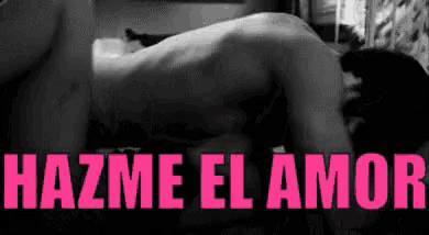 a man and woman are having sex in a black and white photo with the words hazme el amor in pink letters .