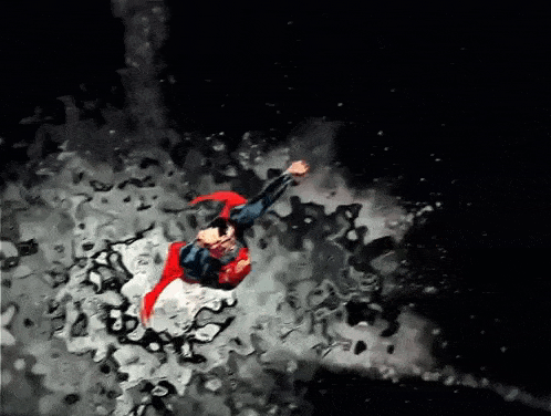 superman is flying through the air with a red cape