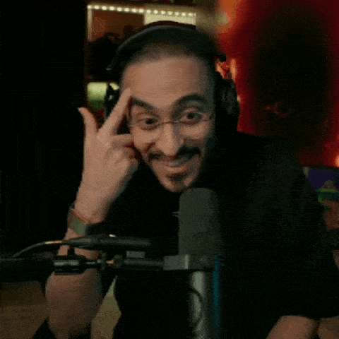 a man wearing headphones is sitting in front of a microphone