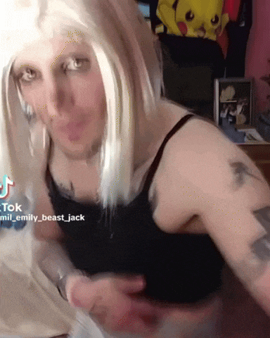a woman with white hair and a black tank top has a tattoo on her arm that says " beast jack "