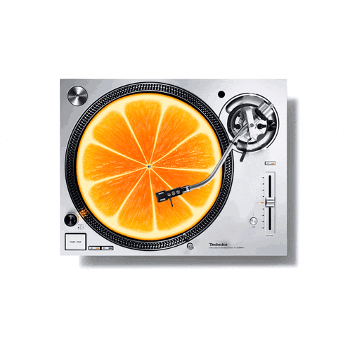 a technics turntable with an orange slice on the record