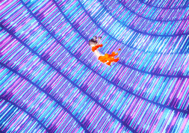 a person is flying through a tunnel of glowing lights .