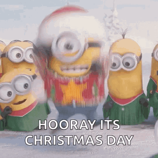 a group of minions are standing next to each other in the snow and they are wearing christmas outfits .