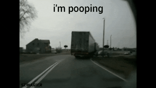a truck driving down a road with the words " i 'm pooping " written on the bottom