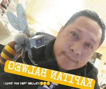 a man with a bee on his shoulder and a sign that says i love you capt ball