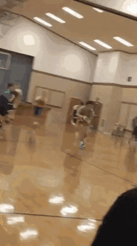 a group of people are playing a game in a gym