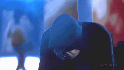 a person in a hooded jacket with miyasalina written on the bottom right