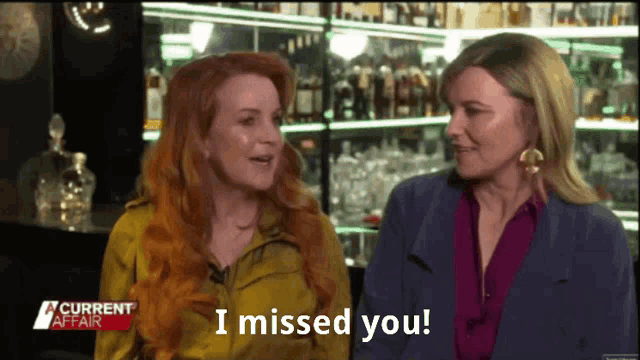 two women sitting next to each other with the words i missed you