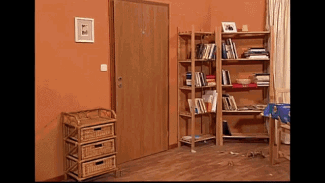 a wicker dresser sits next to a bookshelf in a room