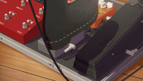 a guitar pedal board with a shoe on it