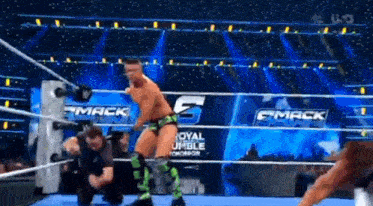 a wrestler in a wrestling ring with the words royal rumble tomorrow