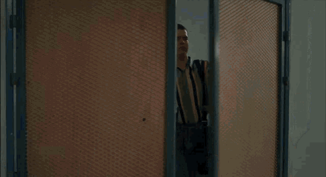 two men standing next to each other in a room