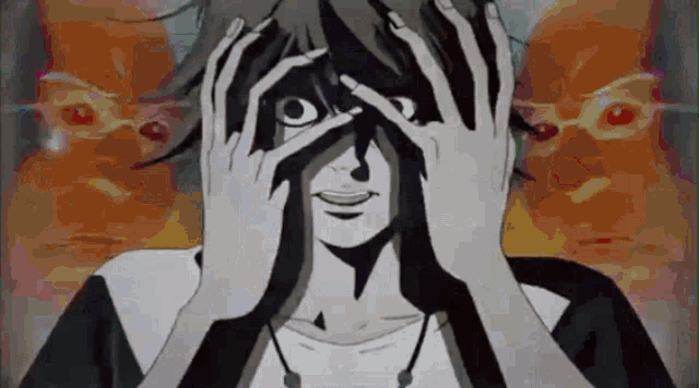 a person is covering their eyes with their hands while another person looks on .
