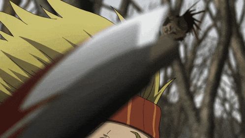 a close up of a person holding a knife with trees in the background